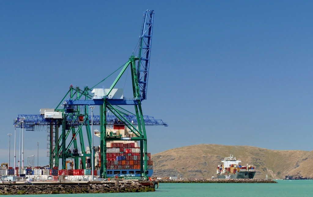Port gantry cranes against a clear sky